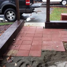 Paver installation in progress during porch remodel