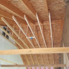 Ceiling joists installed for new ceiling on porch remodel