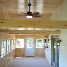 Completed porch remodel with new ceiling fan, new carpet and 3 coats of polyurethane an pine woodwork